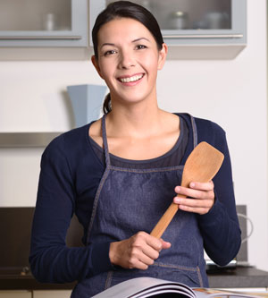 Woman smiling and cooking after LASIK 