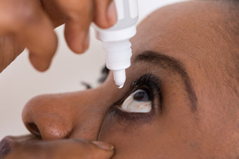 Woman Putting In Eye Drops
